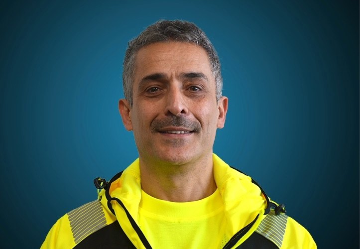 Portraitfoto eines Fahrers von CAPITAL Baustoffe vor einem blauem Hintergrund