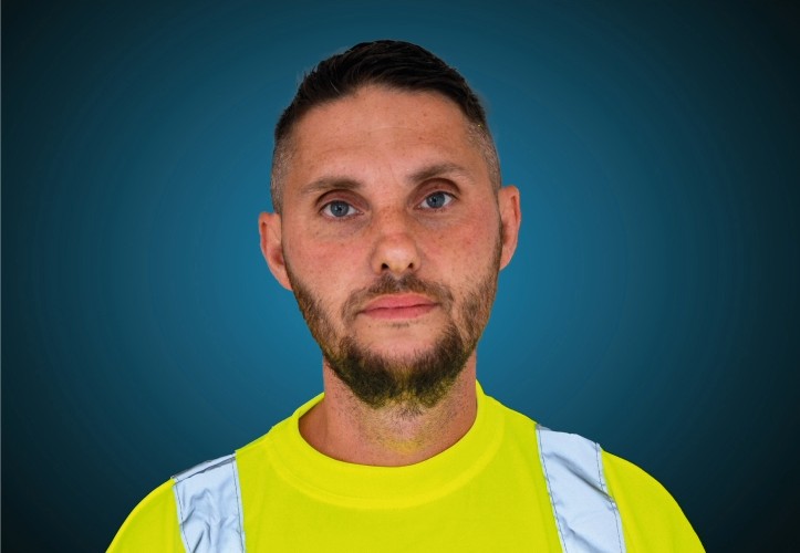 Portraitfoto eines Fahrers von CAPITAL Baustoffe vor einem blauem Hintergrund